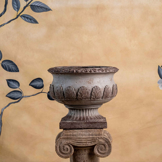 Decorative urn with floral arch on a beige background