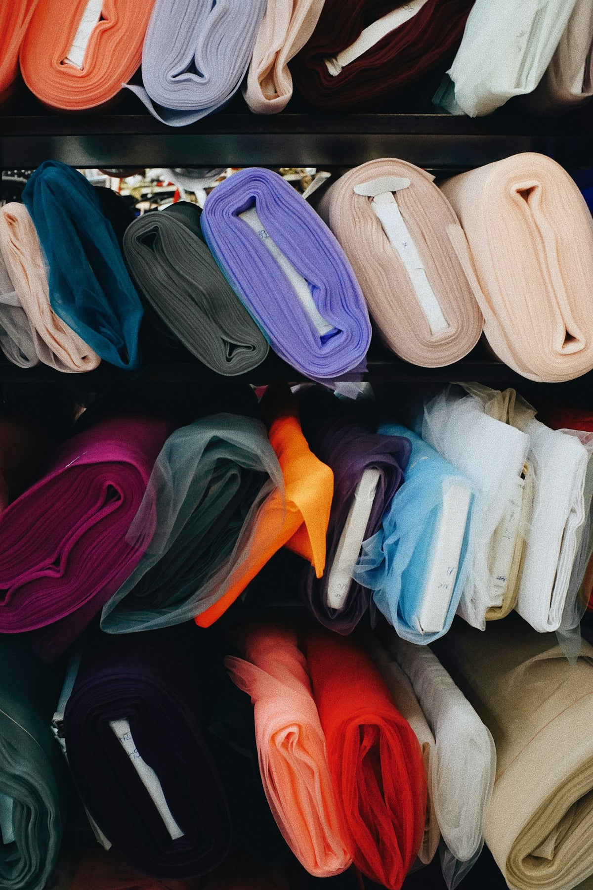 Bolts of cloth on the shelves of a fabric library